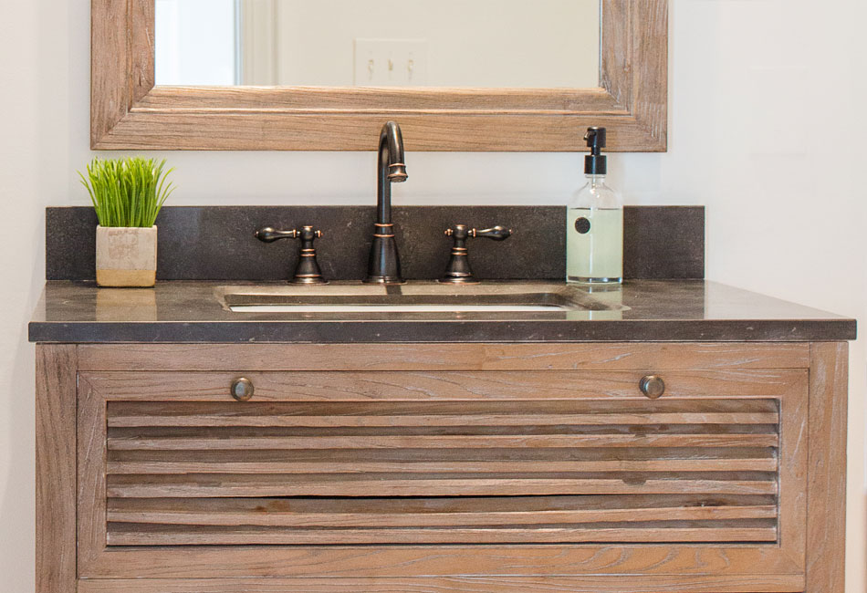 The vanity and mirror used in the powder room  of The Arched Manor