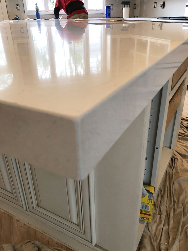 The island countertop has a 2.5 inch mitered edge