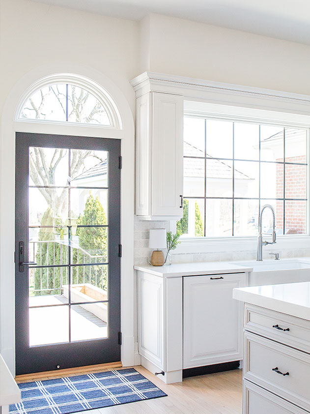 The kitchen received a new door with black grilles and a large black grille window over the sink. 