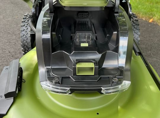 The battery goes into the front of the Green Machine Lawn Mower