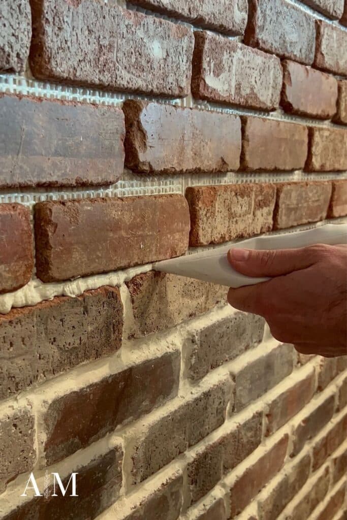 Piping grout on brick wall