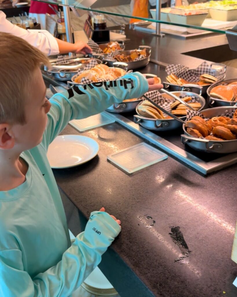 Charlie selecting just the right waffle at The Grand Buffet breakfast