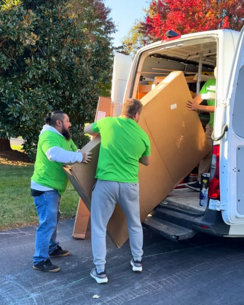 The crew unloading one of the windows from their van.
