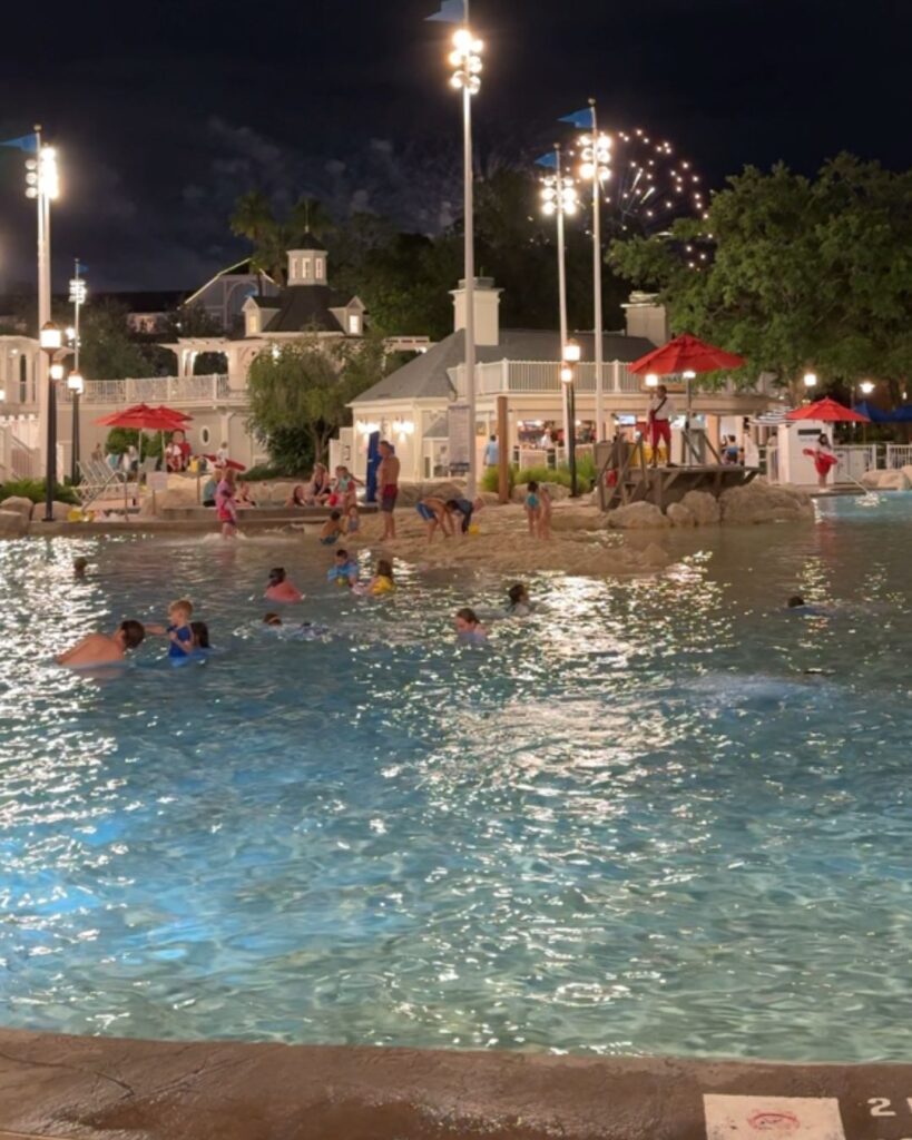 Stormalong Bay Pool at night with the Epcot fireworks show